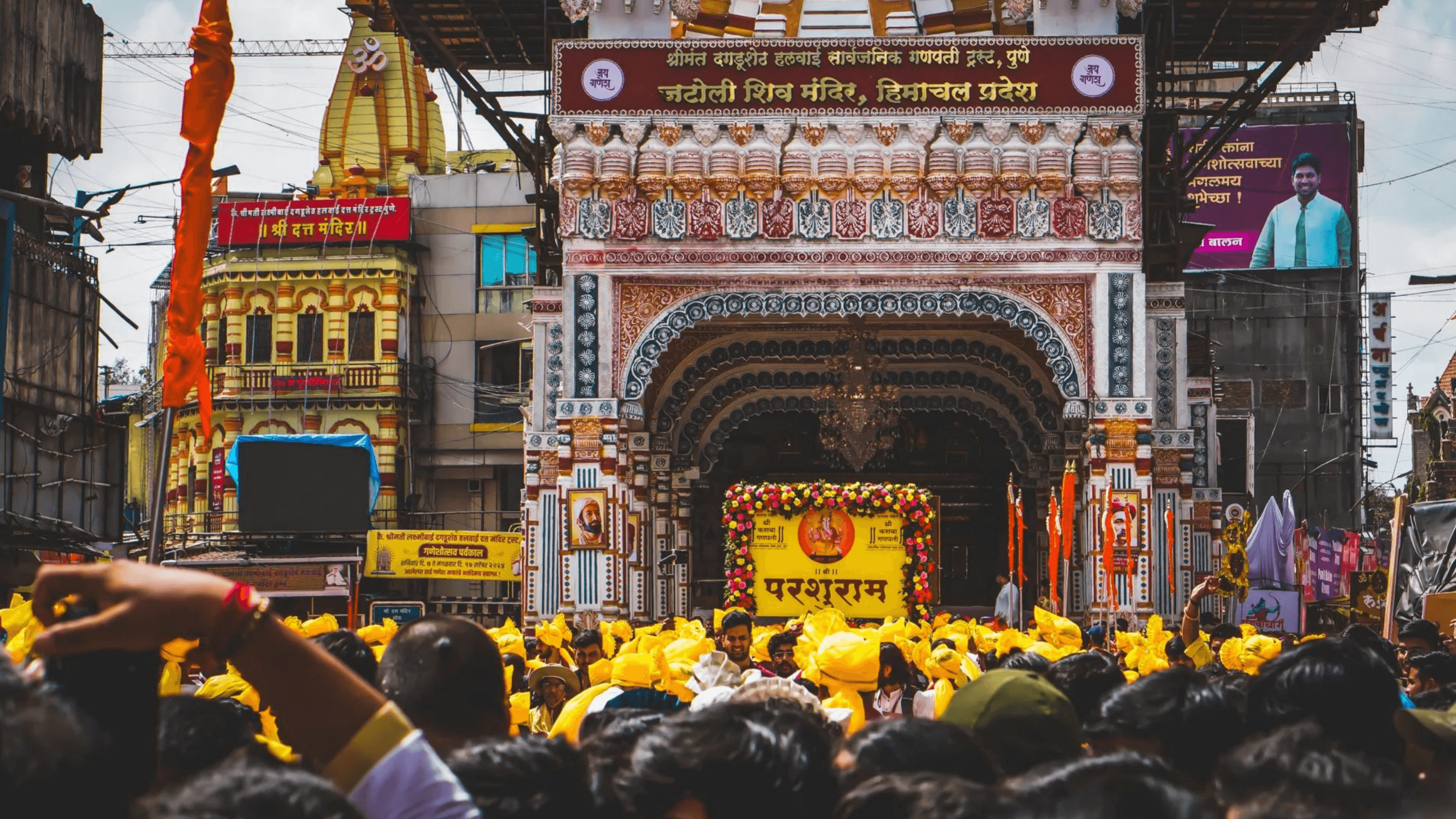 Dhol Tasha players in action in front of a fort