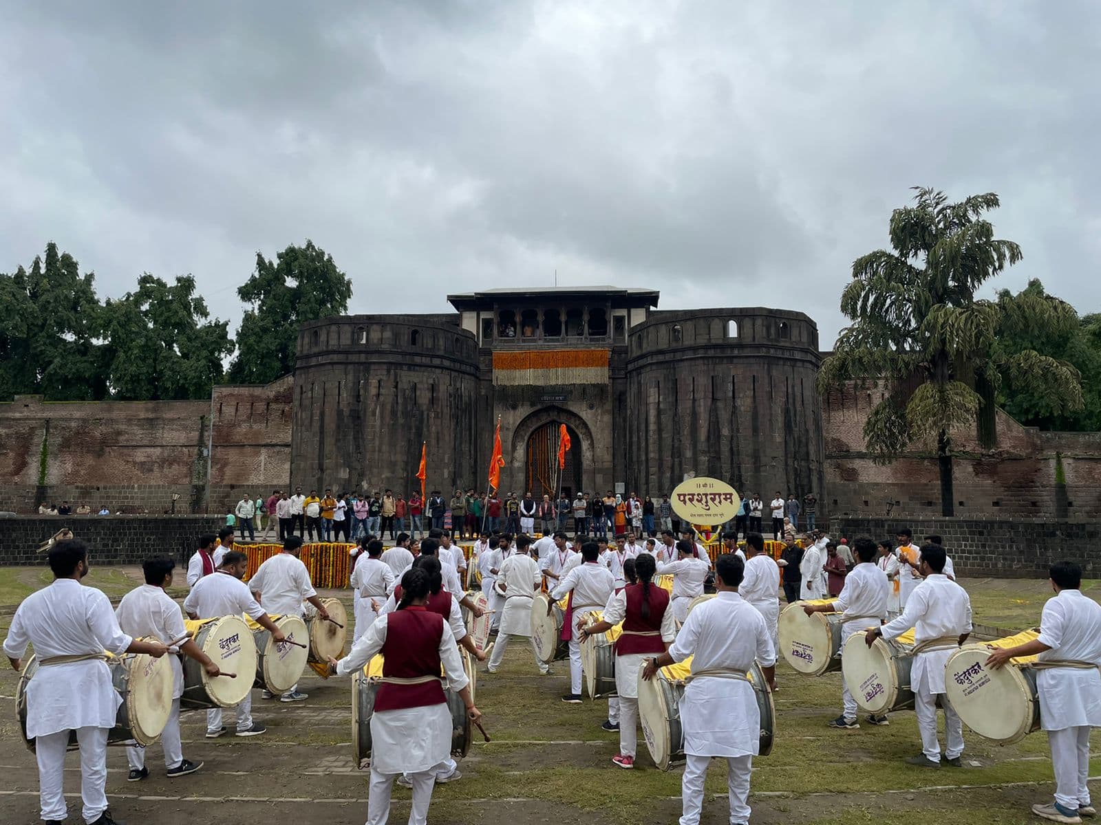 A festive procession with orange flags.