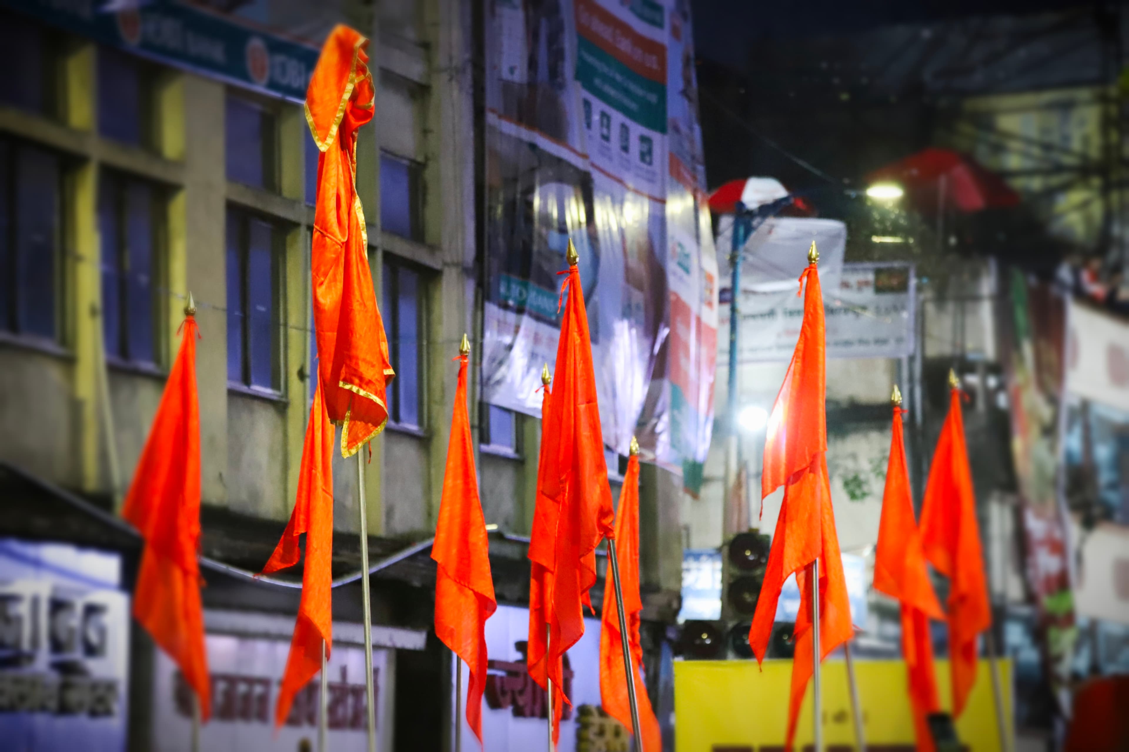 A festive procession with orange flags.